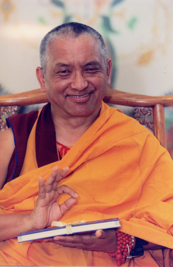 Portrait of Lama Zopa Rinpoche holding a book and smiling. Malaysia, estimated date 2000.