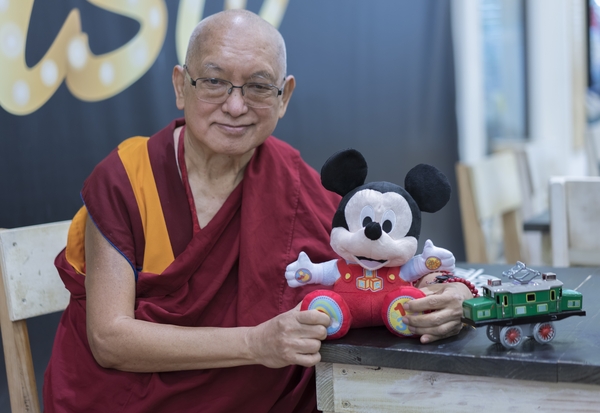 Rinpoche with gifts he bought for Osel's son