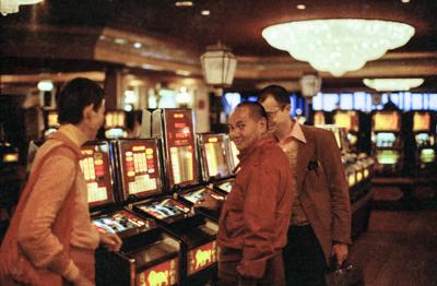 Lama Yeshe with the "one-arm-bandits" (and Ven. John Feuille) at the MGM in Reno, Nevada, 1977. Photo by Anila Ann McNeil.
