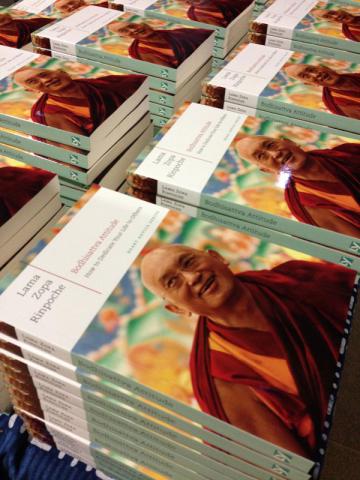 Neatly stacked copies of Bodhisattva Attitude, a book by Lama Zopa Rinpoche.